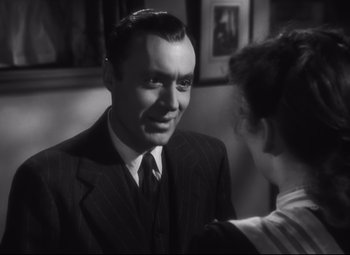 Movie still from “Cluny Brown” (1946), directed by Ernst Lubitsch – A man and a woman in a suit and tie talking; Close Up shot, Over the shoulder angle