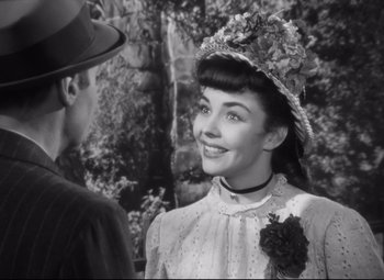 Movie still from “Cluny Brown” (1946), directed by Ernst Lubitsch – An old photo of a woman in a dress and a hat; Close Up shot, Over the shoulder angle