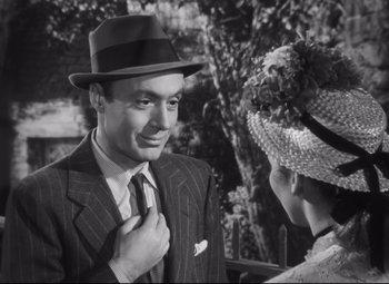 Movie still from “Cluny Brown” (1946), directed by Ernst Lubitsch – A man and a woman in a suit and hat; Close Up shot, Over the shoulder angle