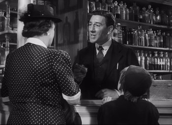 Movie still from “Cluny Brown” (1946), directed by Ernst Lubitsch – An old photo of a man talking to a woman; Medium shot, Low angle