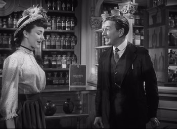 Movie still from “Cluny Brown” (1946), directed by Ernst Lubitsch – A man and a woman standing in front of a counter; Medium shot, Over the shoulder angle