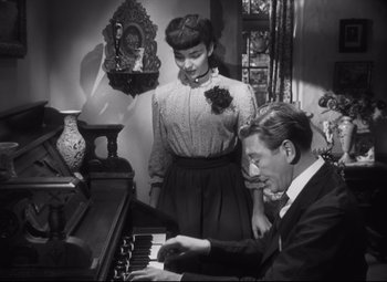 Movie still from “Cluny Brown” (1946), directed by Ernst Lubitsch – A man and a woman are playing the piano; Medium shot, High angle