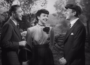 Movie still from “Cluny Brown” (1946), directed by Ernst Lubitsch – A man and two women standing next to each other; Medium shot, High angle