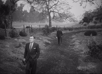 Movie still from “Cluny Brown” (1946), directed by Ernst Lubitsch – Two men in suits are walking down a dirt road; Wide shot, High angle