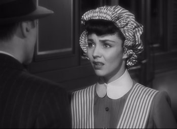 Movie still from “Cluny Brown” (1946), directed by Ernst Lubitsch – A woman wearing a hat and a striped jacket; Close Up shot, Over the shoulder angle