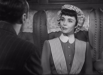 Movie still from “Cluny Brown” (1946), directed by Ernst Lubitsch – An old photo of a man and a woman; Medium shot, Over the shoulder angle