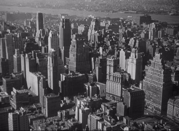 Movie still from “Cluny Brown” (1946), directed by Ernst Lubitsch – An aerial view of a large city with skyscrapers; Extreme Wide shot, Overhead angle