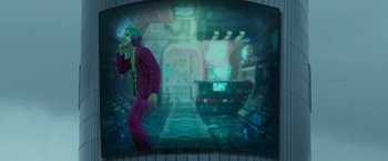 Movie still from “Cobra” (2022), directed by R. Ajay Gnanamuthu – A man in a purple suit standing in front of a window; Medium shot, High angle