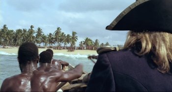 Movie still from “Cobra Verde” (1987), directed by Werner Herzog – A group of people on a boat in the ocean; Close Up shot, High angle