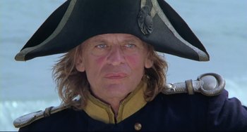 Movie still from “Cobra Verde” (1987), directed by Werner Herzog – A person wearing a hat; Close Up shot, Low angle