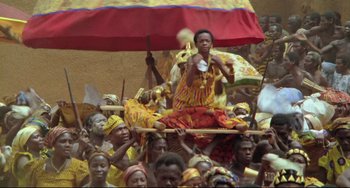 Movie still from “Cobra Verde” (1987), directed by Werner Herzog – A man sitting on top of a wooden stick; Wide shot, High angle