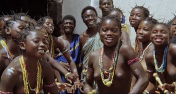 Movie still from “Cobra Verde” (1987), directed by Werner Herzog – A group of young people in traditional clothing; Medium shot, High angle