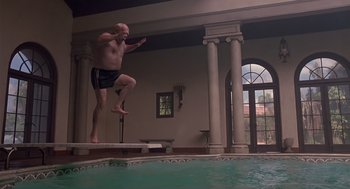 Movie still from “Cocoon” (1985), directed by Ron Howard – A man jumping into a pool of water; Wide shot, Low angle