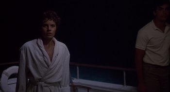 Movie still from “Cocoon” (1985), directed by Ron Howard – A man in a white robe standing in front of a railing at night; Medium shot, Low angle