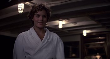 Movie still from “Cocoon” (1985), directed by Ron Howard – A woman in a white robe standing in a room; Close Up shot, Over the shoulder angle