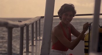 Movie still from “Cocoon” (1985), directed by Ron Howard – A woman in a red top sitting on a boat; Medium shot, Low angle