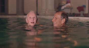 Movie still from “Cocoon” (1985), directed by Ron Howard – Two older people are swimming in a pool; Close Up shot, High angle