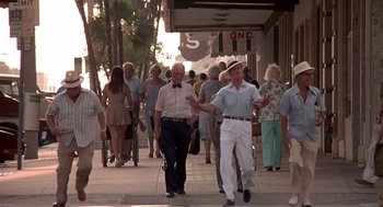 Movie still from “Cocoon” (1985), directed by Ron Howard – A group of people walking down a sidewalk; Wide shot, Low angle