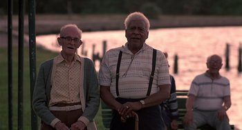 Movie still from “Cocoon” (1985), directed by Ron Howard – Two older men standing next to each other on a park bench; Medium shot, Low angle