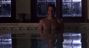 Movie still from “Cocoon” (1985), directed by Ron Howard – A man sitting in a pool of water; Medium shot, Over the shoulder angle