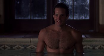 Movie still from “Cocoon” (1985), directed by Ron Howard – A shirtless man sitting in a pool of water at night; Close Up shot, High angle