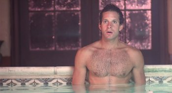 Movie still from “Cocoon” (1985), directed by Ron Howard – A man sitting in a hot tub with no shirt on; Close Up shot, High angle