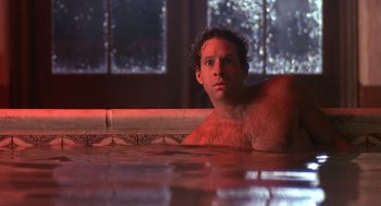 Movie still from “Cocoon” (1985), directed by Ron Howard – A man sitting in a hot tub in a bathroom; Close Up shot, Low angle