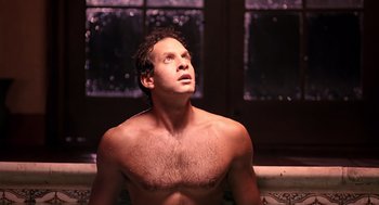 Movie still from “Cocoon” (1985), directed by Ron Howard – A shirtless man sitting in a bath tub; Close Up shot, Low angle