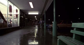 Movie still from “Cocoon” (1985), directed by Ron Howard – A man walking in a parking lot at night; Wide shot, Low angle
