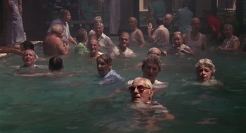 Movie still from “Cocoon” (1985), directed by Ron Howard – A group of people swimming in a body of water; Wide shot, High angle