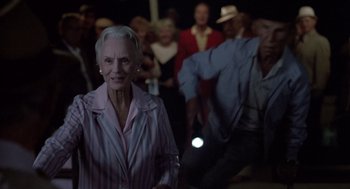 Movie still from “Cocoon” (1985), directed by Ron Howard – An older woman in a crowd of older people; Medium shot, Low angle