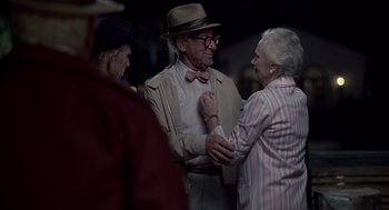 Movie still from “Cocoon” (1985), directed by Ron Howard – An older man wearing a hat and bow tie; Medium shot, Over the shoulder angle