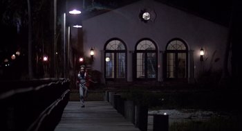 Movie still from “Cocoon” (1985), directed by Ron Howard – A man walking down a sidewalk at night; Extreme Wide shot, Low angle