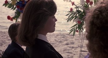 Movie still from “Cocoon” (1985), directed by Ron Howard – A woman standing in front of the water; Close Up shot, Over the shoulder angle