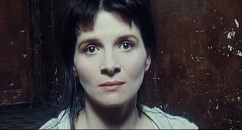 Movie still from “Code Unknown” (2000), directed by Michael Haneke – A person wearing a white shirt; Extreme Close Up shot, Overhead angle