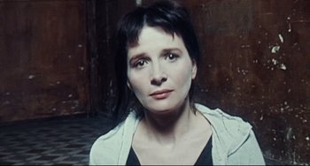 Movie still from “Code Unknown” (2000), directed by Michael Haneke – A person wearing a white shirt; Close Up shot, High angle