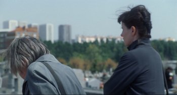 Movie still from “Code Unknown” (2000), directed by Michael Haneke – Two people looking out over a city skyline; Close Up shot, Over the shoulder angle