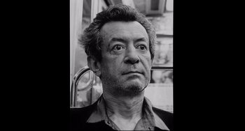 Movie still from “Code Unknown” (2000), directed by Michael Haneke – Black and white photograph of a man in a bus; Close Up shot, Low angle