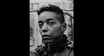 Movie still from “Code Unknown” (2000), directed by Michael Haneke – Black and white photograph of a man with sunglasses; Close Up shot, Low angle