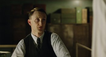 Movie still from “The Death of Stalin” (2017), directed by Armando Iannucci – A man in a vest and tie looking to his left; Close Up shot, Low angle