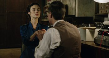 Movie still from “The Death of Stalin” (2017), directed by Armando Iannucci – A man and a woman holding hands in front of each other; Medium shot, Over the shoulder angle