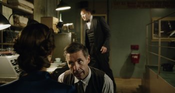 Movie still from “The Death of Stalin” (2017), directed by Armando Iannucci – A man and a woman standing next to each other in a room; Medium shot, Over the shoulder angle