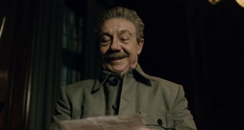 Movie still from “The Death of Stalin” (2017), directed by Armando Iannucci – An old man with a mustache and a beard is smiling for the camera; Close Up shot, Low angle