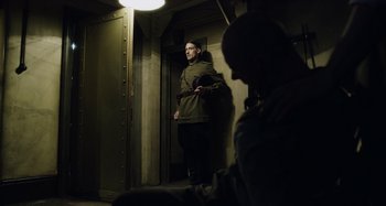 Movie still from “The Death of Stalin” (2017), directed by Armando Iannucci – A man standing in front of another man in a room; Medium shot, Low angle