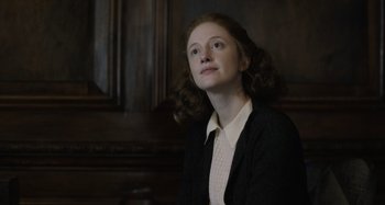 Movie still from “The Death of Stalin” (2017), directed by Armando Iannucci – A woman in a black jacket and a white shirt is looking up; Close Up shot, Low angle