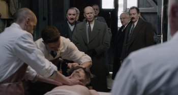 Movie still from “The Death of Stalin” (2017), directed by Armando Iannucci – A group of men standing in a room; Medium shot, Over the shoulder angle