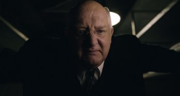 Movie still from “The Death of Stalin” (2017), directed by Armando Iannucci – An older man wearing a suit and tie; Close Up shot, Low angle