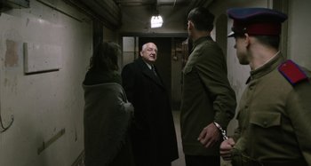 Movie still from “The Death of Stalin” (2017), directed by Armando Iannucci – A group of people standing in a hallway; Medium shot, Over the shoulder angle