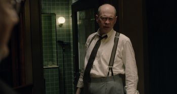 Movie still from “The Death of Stalin” (2017), directed by Armando Iannucci – A bald man in a white shirt and black tie; Medium shot, Over the shoulder angle