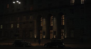 Movie still from “The Death of Stalin” (2017), directed by Armando Iannucci – An image of an old car parked on the side of the road at night; Extreme Wide shot, Low angle